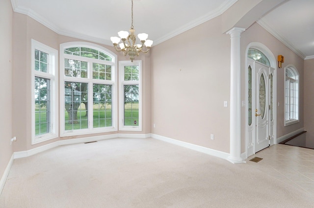 carpeted spare room featuring an inviting chandelier, crown molding, and decorative columns