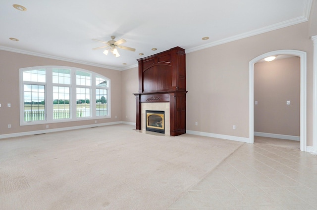 unfurnished living room with ornamental molding, a fireplace, and ceiling fan