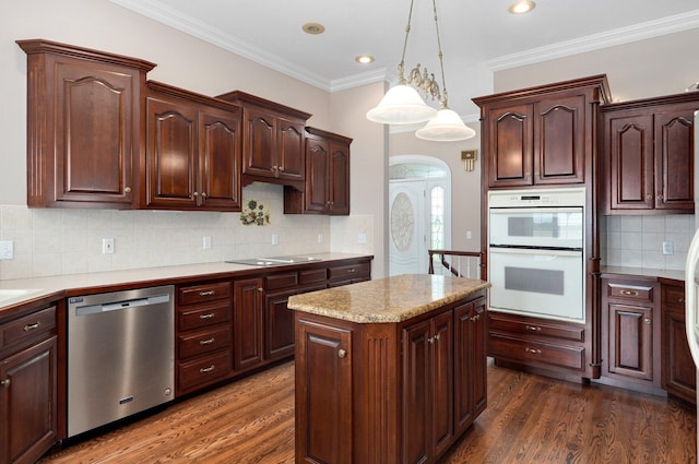 kitchen featuring dishwasher, dark hardwood / wood-style floors, double oven, and ornamental molding