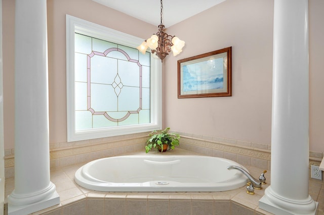 bathroom with a chandelier and a relaxing tiled tub