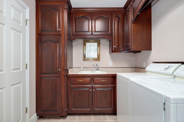 washroom featuring independent washer and dryer, cabinets, sink, and light tile patterned floors