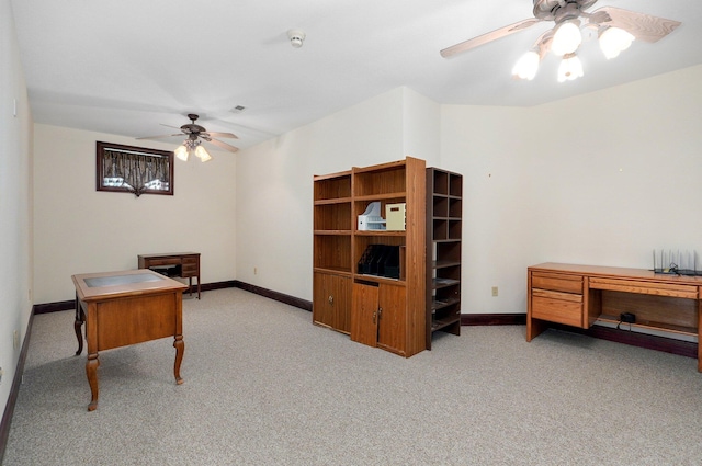 carpeted office space featuring ceiling fan