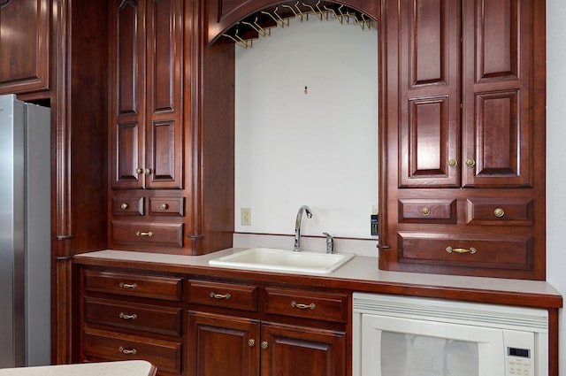 kitchen featuring stainless steel refrigerator and sink