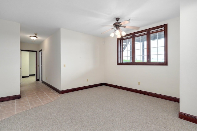 unfurnished room featuring light colored carpet and ceiling fan