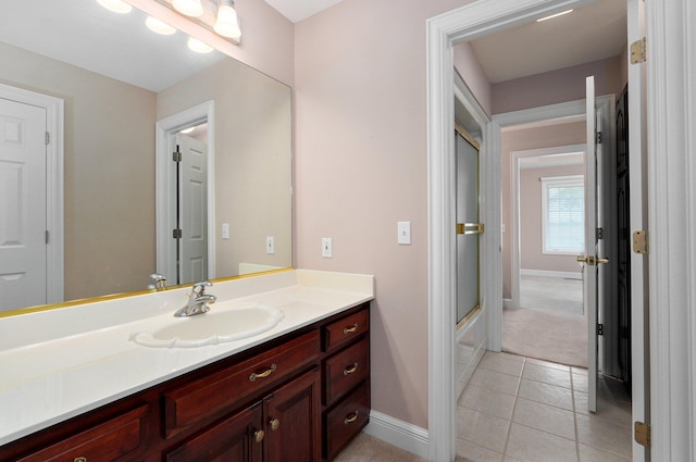 bathroom featuring tile patterned flooring, shower / bath combination with glass door, and vanity