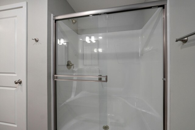 bathroom with a shower with door