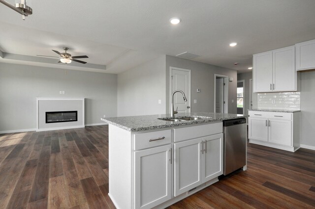 kitchen featuring dishwasher, sink, dark hardwood / wood-style flooring, and white cabinetry