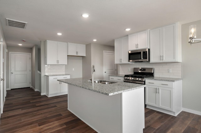 kitchen with dark hardwood / wood-style floors, sink, stainless steel appliances, and white cabinets