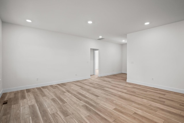 spare room with recessed lighting, visible vents, light wood finished floors, and baseboards
