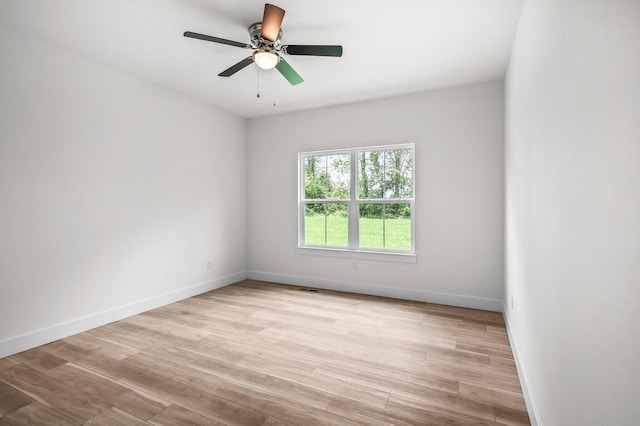 unfurnished room with ceiling fan, baseboards, light wood-style floors, and visible vents