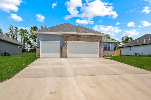 view of front of property with brick siding, an attached garage, driveway, and a front lawn