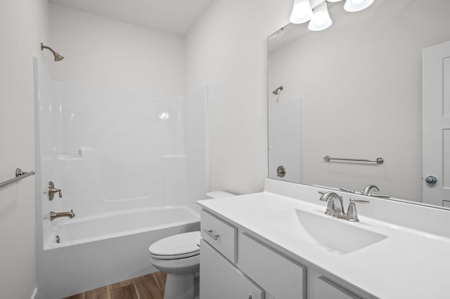 full bath with wood finished floors, toilet, vanity, and bathing tub / shower combination