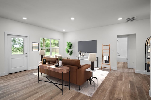 living area with baseboards, visible vents, recessed lighting, and light wood-style floors