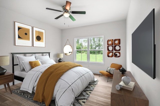 bedroom with light hardwood / wood-style floors and ceiling fan