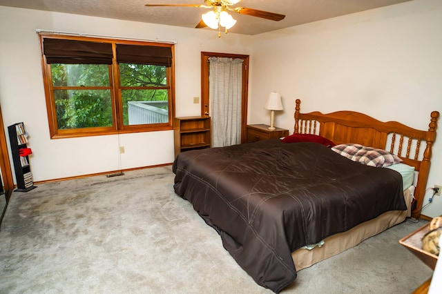 bedroom featuring ceiling fan and light carpet