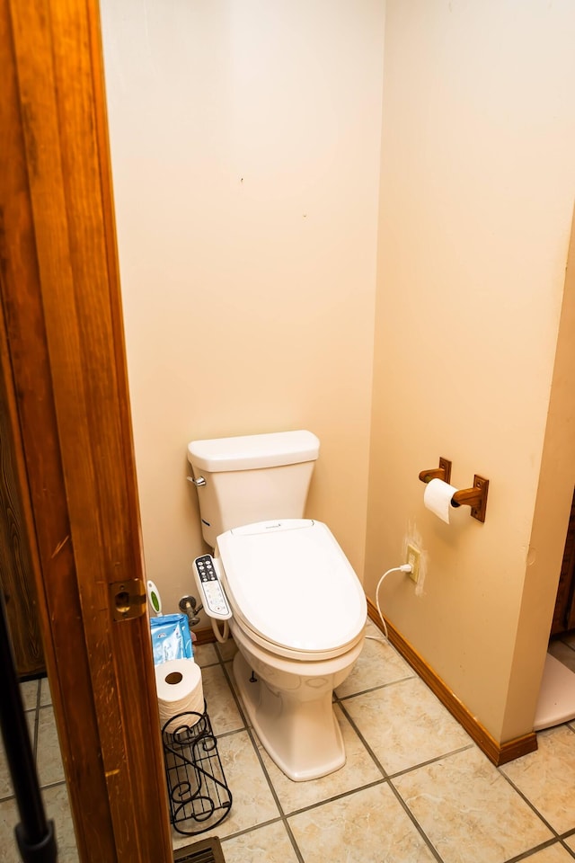 bathroom with tile patterned flooring and toilet