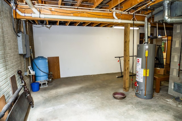 basement with electric panel and water heater