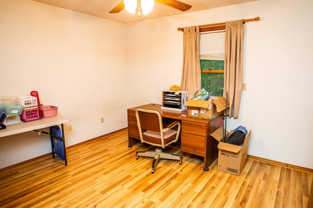 home office with light wood-type flooring and ceiling fan