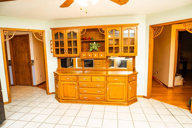 kitchen featuring ceiling fan and light hardwood / wood-style flooring