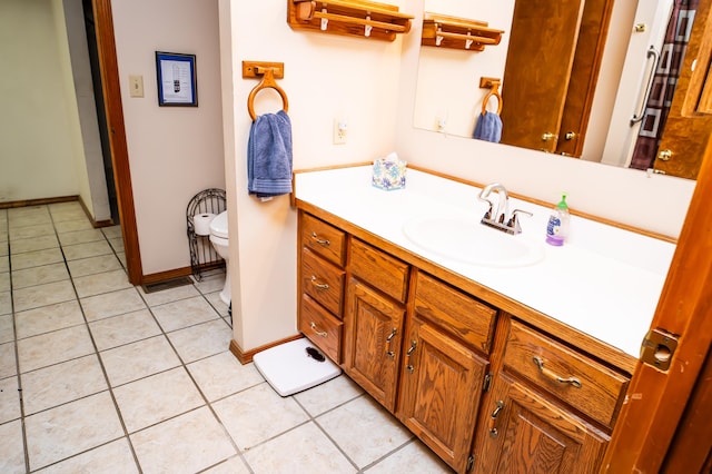 bathroom featuring tile patterned floors, toilet, and vanity