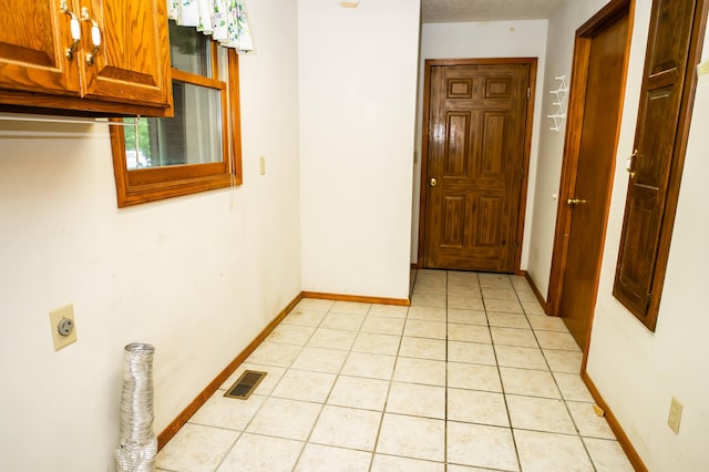 corridor with light tile patterned flooring