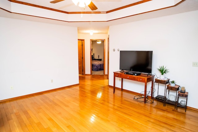 living room with ornamental molding, hardwood / wood-style flooring, and ceiling fan