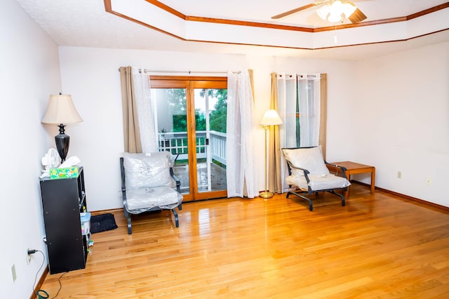 living area featuring ceiling fan and hardwood / wood-style floors