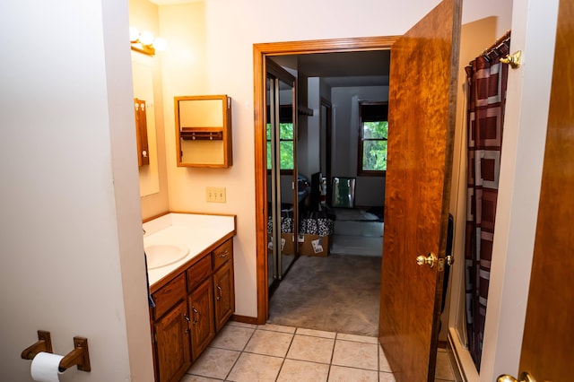 bathroom featuring tile patterned flooring and vanity