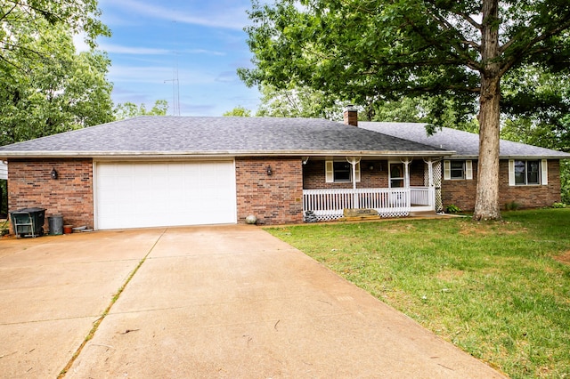 single story home with a garage, a front lawn, and covered porch