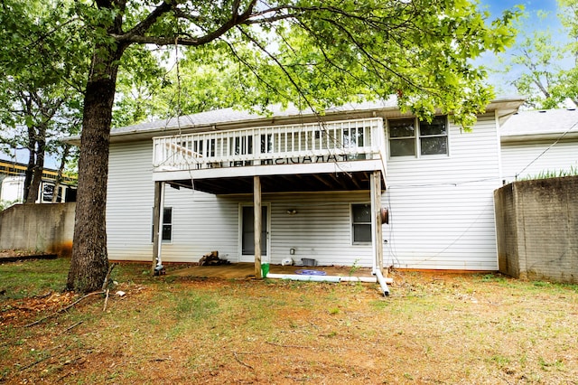 back of property featuring a wooden deck