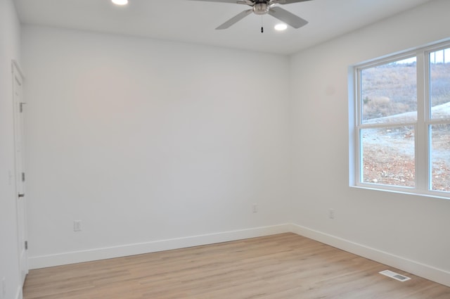 empty room featuring ceiling fan and light hardwood / wood-style floors