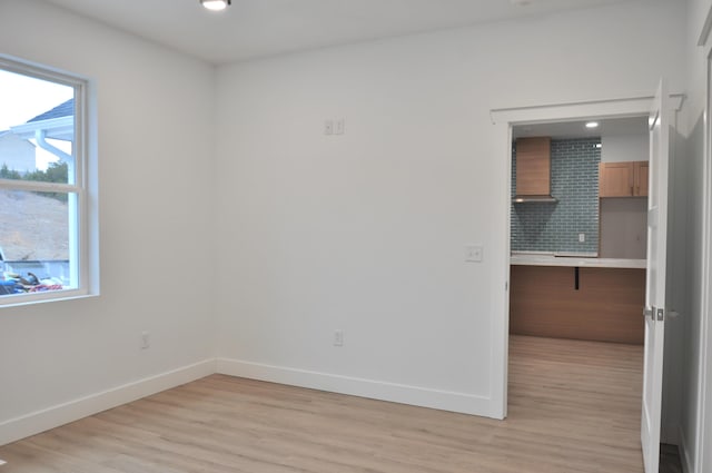 spare room with light hardwood / wood-style floors