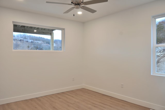 unfurnished room with ceiling fan and light hardwood / wood-style floors