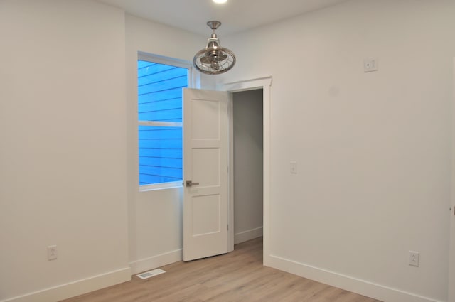 spare room featuring light wood-type flooring