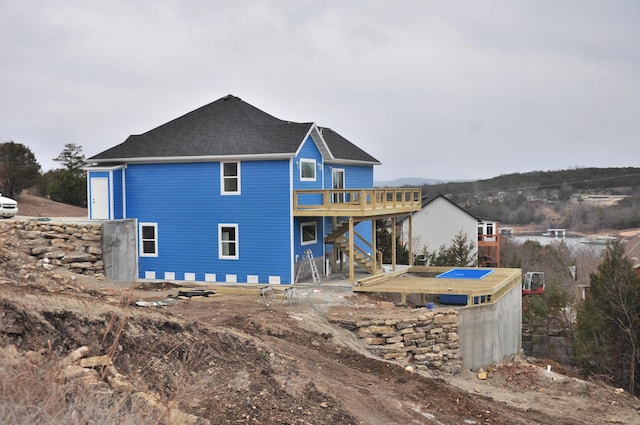 rear view of property featuring a deck