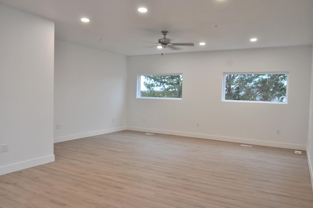 unfurnished room with ceiling fan and light hardwood / wood-style floors