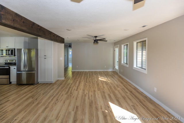 unfurnished living room featuring light wood-type flooring, beamed ceiling, and ceiling fan