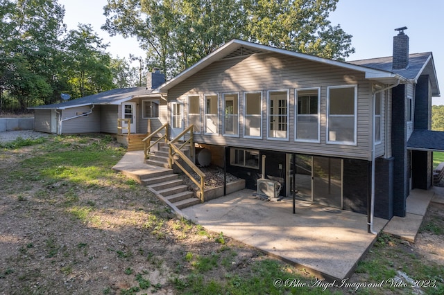 back of property with a carport and a patio area