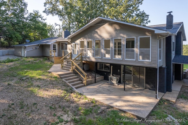 back of property featuring a patio area and a chimney
