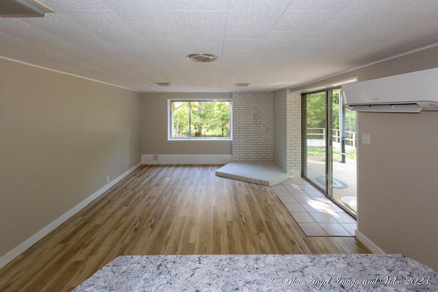 spare room with hardwood / wood-style flooring and a fireplace