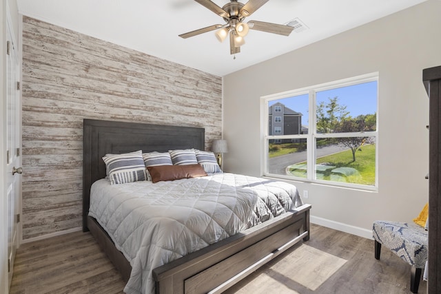 3006 N Vineyards Ter Unit 2, Branson, MO 65616 - bedroom with an accent wall, wood finished floors, ceiling fan, baseboards, and visible vents