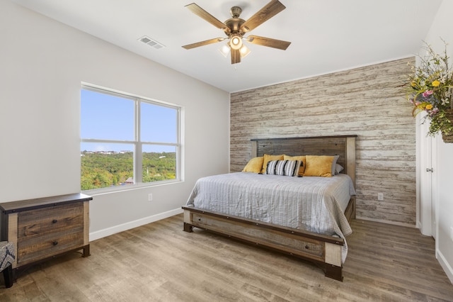 3006 N Vineyards Ter Unit 2, Branson, MO 65616 - bedroom featuring baseboards, wood finished floors, visible vents, and an accent wall