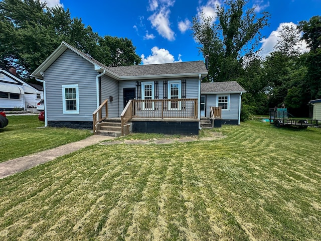 view of front facade with a front yard and a wooden deck