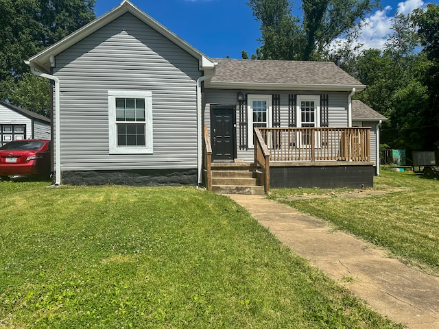 view of front facade featuring a front yard and a deck