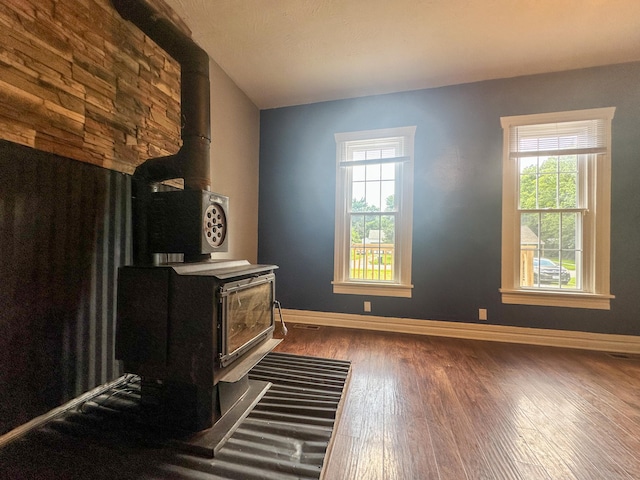 living room with a wood stove and dark hardwood / wood-style flooring