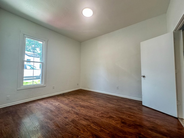 spare room featuring dark hardwood / wood-style flooring