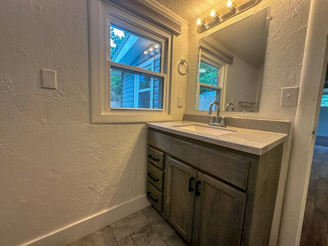 bathroom with vanity and a textured ceiling