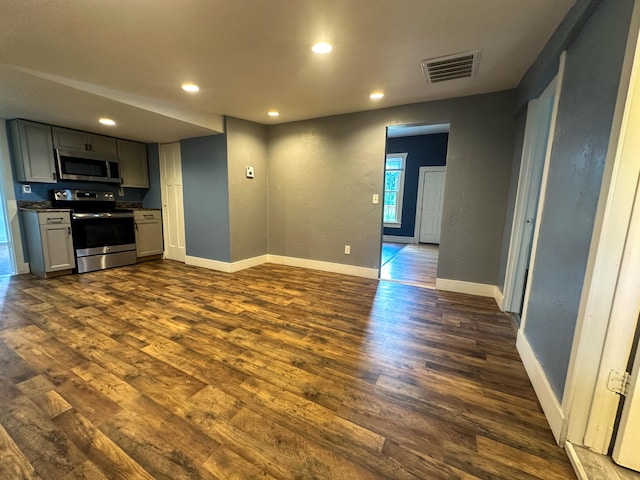 unfurnished living room with dark hardwood / wood-style flooring