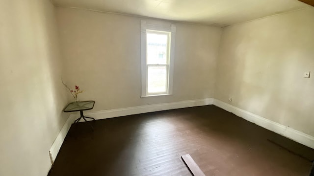 unfurnished room with dark hardwood / wood-style flooring