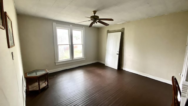 spare room featuring ceiling fan and dark wood-type flooring